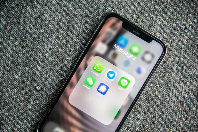 Smartphone screen showing a folder of messaging apps, representing constant digital interruption