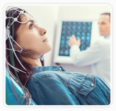 Research participant wearing an EEG cap while brain activity is recorded in a lab